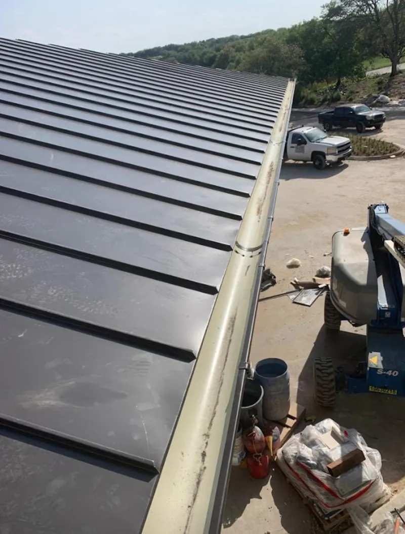 Standing seam panel and gutter detail on a metal roofing jobsite in North Oaks